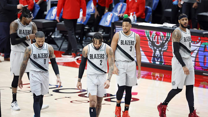 Mar 16, 2021; Portland, Oregon, USA; Portland Trail Blazers (from left to right) Robert Covington (23), Damian Lillard (0), Gary Trent Jr. (2), CJ McCollum (3), and Carmelo Anthony (00) walk back to the court after a timeout during the second half against the New Orleans Pelicans at Moda Center. Mandatory Credit: Soobum Im-Imagn Images