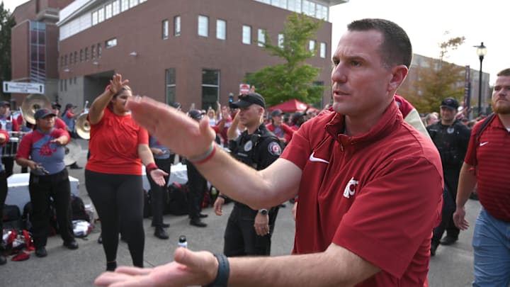 Sep 7, 2024; Pullman, Washington, USA; Washington State Cougars head coach Jake Dickert leads his team into Gesa Field at Martin Stadium before a game against the Texas Tech Red Raiders. Mandatory Credit: James Snook-Imagn Images