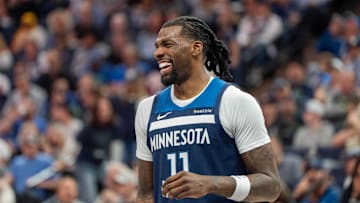 Apr 13, 2025; Minneapolis, Minnesota, USA; Minnesota Timberwolves center Naz Reid (11) laughs with a teammate during a stoppage in the fourth quarter against the Utah Jazz at Target Center. Mandatory Credit: Matt Blewett-Imagn Images