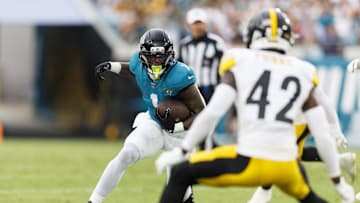 Aug 9, 2025; Jacksonville, Florida, USA; Jacksonville Jaguars running back Travis Etienne Jr. (1) runs the ball against the Pittsburgh Steelers during the first quarter at EverBank Stadium. Mandatory Credit: Morgan Tencza-Imagn Images