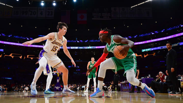 Dec 25, 2023; Los Angeles, California, USA; Boston Celtics guard Jrue Holiday (4) controls the ball against Los Angeles Lakers guard Austin Reaves (15) during the second half at Crypto.com Arena. Mandatory Credit: Gary A. Vasquez-USA TODAY Sports