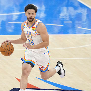 Jun 5, 2025; Oklahoma City, Oklahoma, USA; Oklahoma City Thunder guard Ajay Mitchell (25) dribbles the ball against Indiana Pacers guard T.J. McConnell (9) during the first quarter in game one of the 2025 NBA Finals at Paycom Center. Mandatory Credit: Kyle Terada-Imagn Images