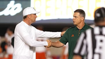 Oct 5, 2024; Berkeley, California, USA; California Golden Bears head coach Justin Wilcox (left) and Miami Hurricanes head coach Mario Cristobal (right) shake hands before the game at California Memorial Stadium. Mandatory Credit: Darren Yamashita-Imagn Images
