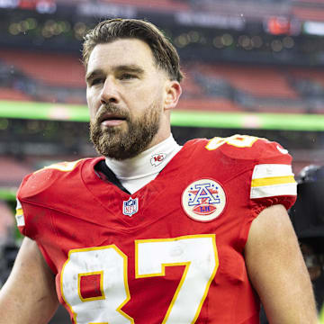 Dec 15, 2024; Cleveland, Ohio, USA; Kansas City Chiefs tight end Travis Kelce (87) gives his gloves to a fan following a game against the Cleveland Browns at Huntington Bank Field. Mandatory Credit: Scott Galvin-Imagn Images
