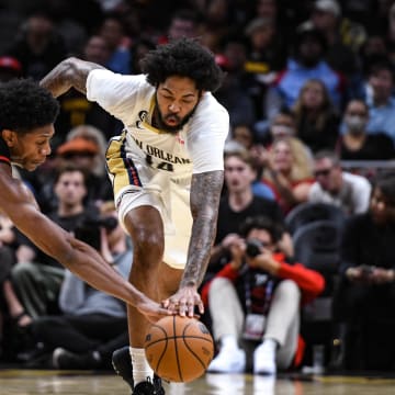 Nov 5, 2022; Atlanta, Georgia, USA; New Orleans Pelicans forward Brandon Ingram (14) fights for a loose ball against Atlanta Hawks forward DeAndre Hunter (12) in the second quarter at State Farm Arena. Mandatory Credit: Larry Robinson-USA TODAY Sports