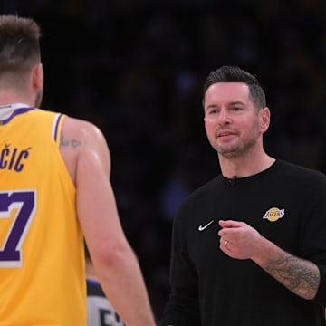 Feb 10, 2025; Los Angeles, California, USA; Los Angeles Lakers guard Luka Doncic (77) is greeted by head coach JJ Redick during a time out against the Utah Jazz at Crypto.com Arena. Mandatory Credit: Jayne Kamin-Oncea-Imagn Images