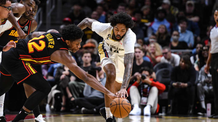 Nov 5, 2022; Atlanta, Georgia, USA; New Orleans Pelicans forward Brandon Ingram (14) fights for a loose ball against Atlanta Hawks forward DeAndre Hunter (12) in the second quarter at State Farm Arena. Mandatory Credit: Larry Robinson-USA TODAY Sports