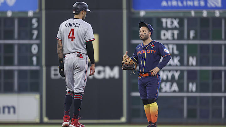 Minnesota Twins shortstop Carlos Correa (4) talks with Houston Astros second baseman Jose Altuve (27) on May 29, 2023 in Houston.