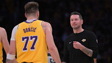 Feb 10, 2025; Los Angeles, California, USA; Los Angeles Lakers guard Luka Doncic (77) is greeted by head coach JJ Redick during a time out against the Utah Jazz at Crypto.com Arena. Mandatory Credit: Jayne Kamin-Oncea-Imagn Images
