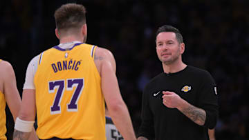 Feb 10, 2025; Los Angeles, California, USA; Los Angeles Lakers guard Luka Doncic (77) is greeted by head coach JJ Redick during a time out against the Utah Jazz at Crypto.com Arena. Mandatory Credit: Jayne Kamin-Oncea-Imagn Images