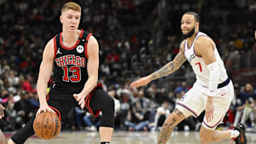 Chicago Bulls guard Kevin Huerter (13) moves the ball past LA Clippers guard Amir Coffey (7) during the second half at the United Center. Mandatory Credit: Matt Marton-Imagn Images
