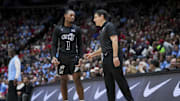 Dec 20, 2024; Cincinnati, Ohio, USA;  Cincinnati Bearcats guard Day Day Thomas (1) talks with head coach Wes Miller in the game against the Dayton Flyers in the second half at Heritage Bank Center. Mandatory Credit: Aaron Doster-Imagn Images