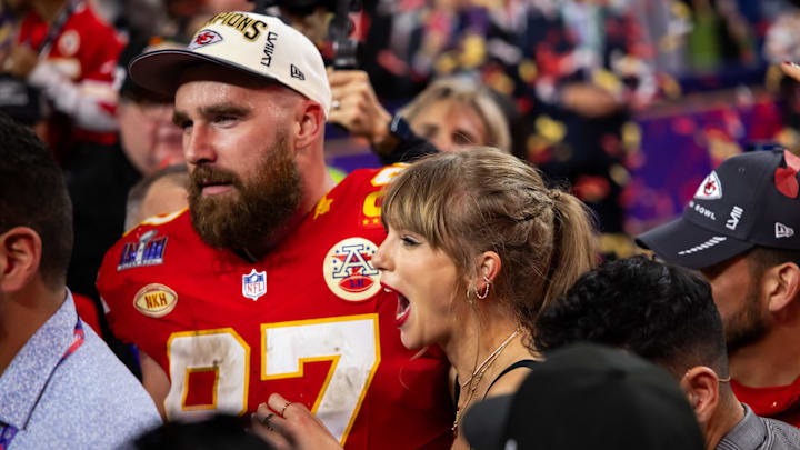 Kansas City Chiefs tight end Travis Kelce (87) celebrates with girlfriend Taylor Swift.