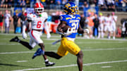 South Dakota State Jackrabbits running back Angel Johnson (21) runs the ball to the end zone for the touchdown after the first kick-off on Saturday, Oct. 12, 2024, at Dana J. Dykhouse Stadium in Brookings.