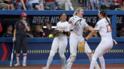 Texas pitcher Teagan Kavan, right, celebrates with Reese Atwood, center, and Mia Scott after a Women's College World Series semifinal softball game between the Stanford Cardinal and the Texas Longhorns at Devon Park in Oklahoma City, Monday, June 3, 2024. Texas won 1-0.