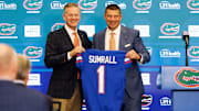 Dec 1, 2025; Gainesville, FL, USA; Florida Gators athletic director Scott Stricklin and Florida Gators head coach Jon Sumrall poses with a Florida Gators jersey during the press conference at the Heavener Football Training Center at the University of Florida. Mandatory Credit: Matt Pendleton-Imagn Images