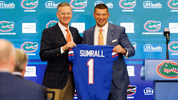 Dec 1, 2025; Gainesville, FL, USA; Florida Gators athletic director Scott Stricklin and Florida Gators head coach Jon Sumrall poses with a Florida Gators jersey during the press conference at the Heavener Football Training Center at the University of Florida. Mandatory Credit: Matt Pendleton-Imagn Images
