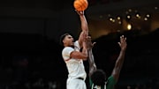 Nov 3, 2025; Coral Gables, Florida, USA; Miami Hurricanes forward Malik Reneau (5) shoots the basketball over Jacksonville Dolphins forward Jaylen Jordon (0) during the first half at Watsco Center. Mandatory Credit: Sam Navarro-Imagn Images