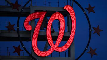The Curly W, surrounded by 3 Stars on either side.
