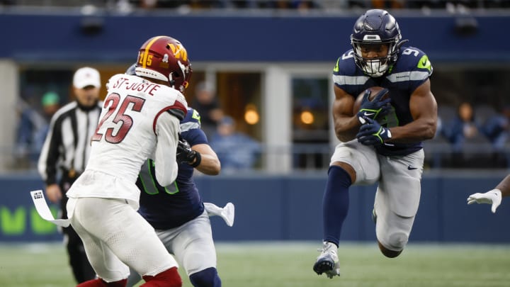 Nov 12, 2023; Seattle, Washington, USA; Seattle Seahawks running back Kenneth Walker III (9) rushes against the Washington Commanders during the second quarter at Lumen Field. 