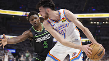 May 20, 2025; Oklahoma City, Oklahoma, USA; Oklahoma City Thunder forward Chet Holmgren (7) controls the ball against Minnesota Timberwolves guard Anthony Edwards (5) in the second quarter during game one of the western conference finals for the 2025 NBA Playoffs at Paycom Center. Mandatory Credit: Alonzo Adams-Imagn Images