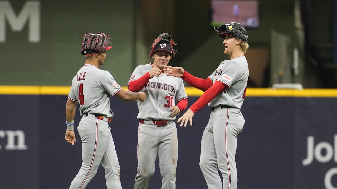 Apr 11, 2026; Milwaukee, Wisconsin, USA; Washington Nationals right fielder Daylen Lile (4), center fielder Jacob Young (30) and left fielder Joey Wiemer (21) celebrate a 3-1 win over the Milwaukee Brewers at American Family Field. Mandatory Credit: Michael McLoone-Imagn Images