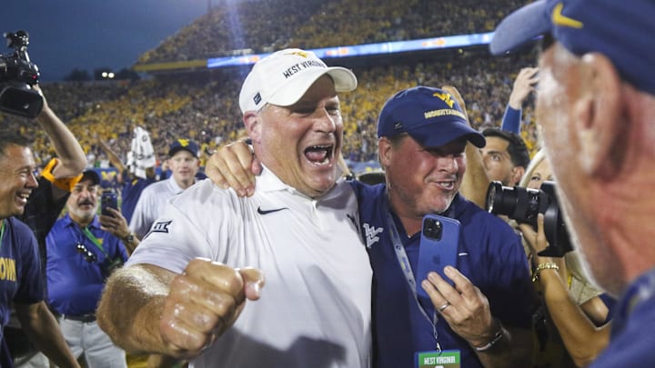 Sep 13, 2025; Morgantown, West Virginia, USA; West Virginia Mountaineers head coach Rich Rodriguez celebrates after defeating the Pittsburgh Panthers at Milan Puskar Stadium. Mandatory Credit: Ben Queen-Imagn Images