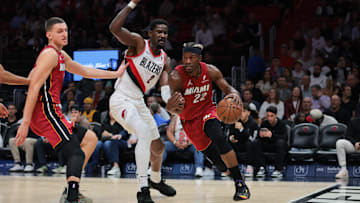 Jan 21, 2025; Miami, Florida, USA; Miami Heat forward Jimmy Butler (22) drives to the basket past Portland Trail Blazers center Deandre Ayton (2) during the first quarter at Kaseya Center. Mandatory Credit: Sam Navarro-Imagn Images