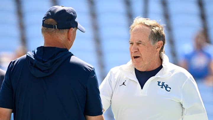 Sep 13, 2025; Chapel Hill, North Carolina, USA; North Carolina Tar Heels head coach Bill Belichick greets Richmond Spiders head coach Russ Huesman before the game at Kenan Stadium. Mandatory Credit: Bob Donnan-Imagn Images