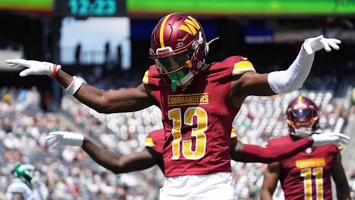 Aug 10, 2024; East Rutherford, New Jersey, USA; Washington Commanders cornerback Emmanuel Forbes (13) celebrates after breaking up a pass to New York Jets wide receiver Mike Williams (18) during the first quarter at MetLife Stadium. Mandatory Credit: Lucas Boland-Imagn Images