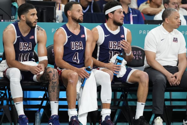 Team USA's Jayson Tatum, Stephen Curry, and Devin Booker look on during a game vs. Puerto Rico at the Paris 2024 Olympics.