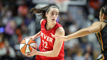 Sep 25, 2024; Uncasville, Connecticut, USA; Indiana Fever guard Caitlin Clark (22) possesses the ball during the first half against the Connecticut Sun during game two of the first round of the 2024 WNBA Playoffs at Mohegan Sun Arena. Mandatory Credit: Paul Rutherford-Imagn Images