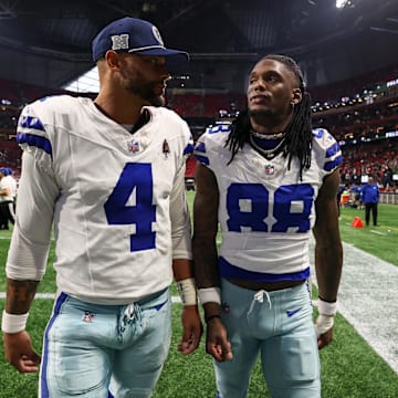 Dallas Cowboys quarterback Dak Prescott and wide receiver CeeDee Lamb walk off the field 