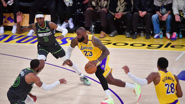 Apr 30, 2025; Los Angeles, California, USA; Los Angeles Lakers forward LeBron James (23) moves to the basket against Minnesota Timberwolves forward Jaden McDaniels (3) and guard Mike Conley (10) during the second half in game five of first round for the 2025 NBA Playoffs at Crypto.com Arena. Mandatory Credit: Gary A. Vasquez-Imagn Images