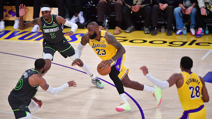Apr 30, 2025; Los Angeles, California, USA: Los Angeles Lakers forward LeBron James (23) moves to the basket against Minnesota Timberwolves forward Jaden McDaniels (3) and guard Mike Conley (10) during the second half in game five of first round for the 2025 NBA Playoffs at Crypto.com Arena. Mandatory Credit: Gary A. Vasquez-Imagn Images