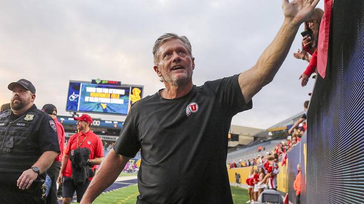 Sep 27, 2025; Morgantown, West Virginia, USA; Utah Utes head coach Kyle Whittingham celebrates with fans after defeating the West Virginia Mountaineers at Milan Puskar Stadium. Mandatory Credit: Ben Queen-Imagn Images