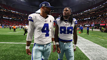 Dallas Cowboys quarterback Dak Prescott and wide receiver CeeDee Lamb walk off the field after a loss against the Atlanta Falcons at Mercedes-Benz Stadium. 