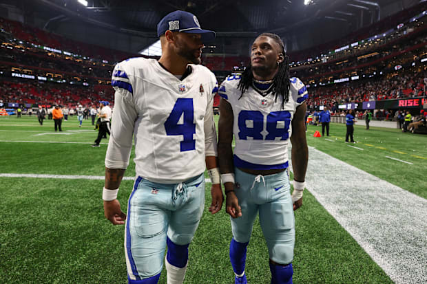Dallas Cowboys quarterback Dak Prescott (4) and wide receiver CeeDee Lamb (88) walk off the field after a loss against the At