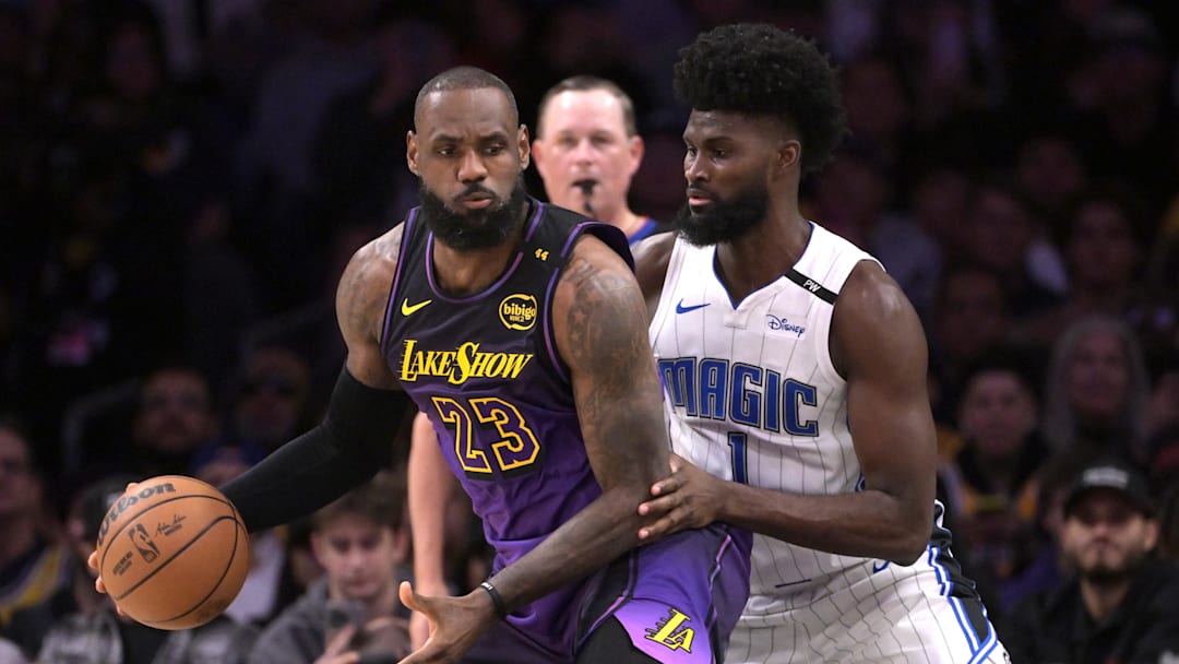 Nov 21, 2024; Los Angeles, California, USA; Los Angeles Lakers forward LeBron James (23) is defended by Orlando Magic forward Jonathan Isaac (1) in the first half at Crypto.com Arena. Mandatory Credit: Jayne Kamin-Oncea-Imagn Images
