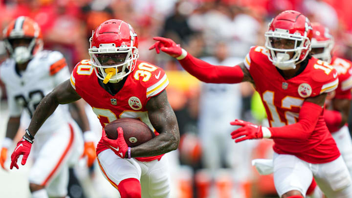 Aug 26, 2023; Kansas City, Missouri, USA; Kansas City Chiefs cornerback Dicaprio Bootle (30) returns an interception as cornerback Kahlef Hailassie (12) looks on during the second half against the Cleveland Browns at GEHA Field at Arrowhead Stadium. Mandatory Credit: Jay Biggerstaff-Imagn Images