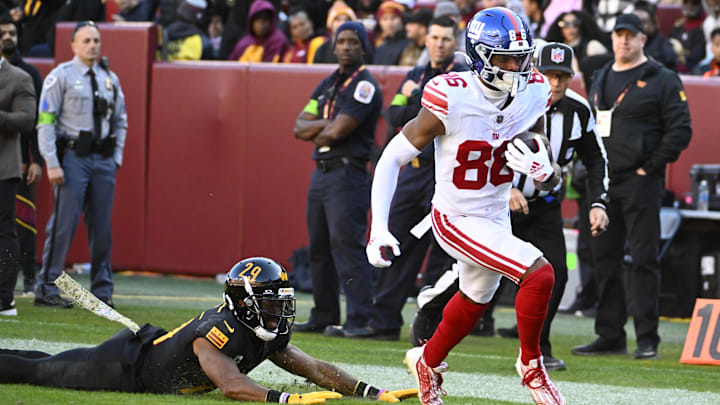 Nov 19, 2023; Landover, Maryland, USA; New York Giants wide receiver Darius Slayton (86) runs for a touchdown as Washington Commanders cornerback Kendall Fuller (29) looks on .