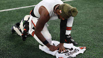 Nov 9, 2025; East Rutherford, New Jersey, USA; Cleveland Browns quarterback Shedeur Sanders (12) signs his jersey on the field after the game against the New York Jets at MetLife Stadium. Mandatory Credit: Vincent Carchietta-Imagn Images