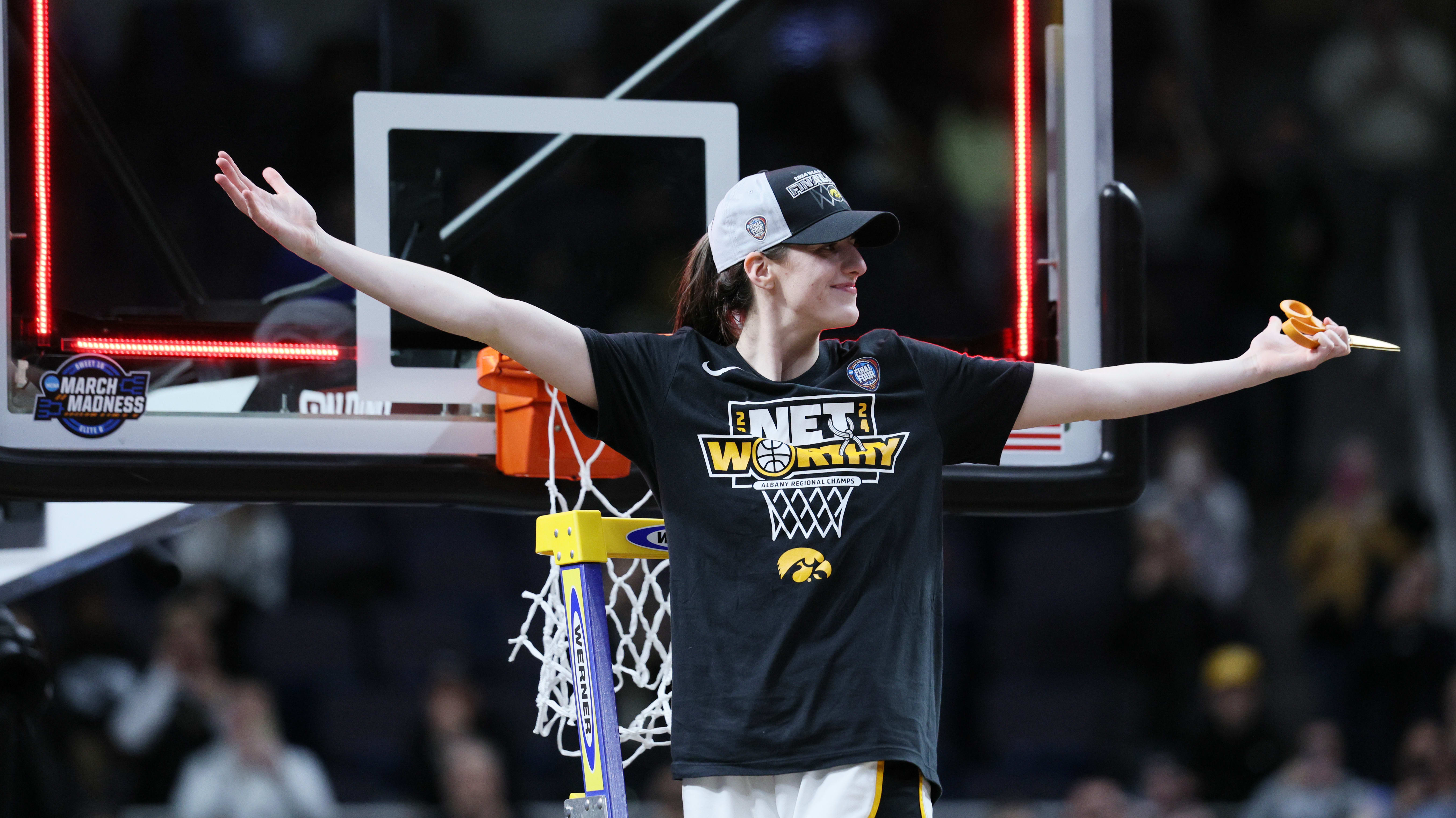 Iowa Hawkeyes star Caitlin Clark cuts the net after defeating LSU in the Elite Eight.