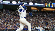 Oct 17, 2025; Los Angeles, California, USA; Los Angeles Dodgers two-way player Shohei Ohtani (17) hits a solo home run against the Milwaukee Brewers in the fourth inning during game four of the NLCS round for the 2025 MLB playoffs at Dodger Stadium. Mandatory Credit: Kirby Lee-Imagn Images