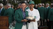 Rory McIlroy and his caddie Harry Diamond celebrate with the trophy after winning the Masters Tournament at Augusta National Golf Club. Mandatory Credit: Michael Madrid-Imagn Images