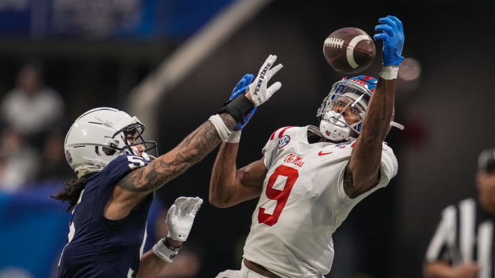 Dec 30, 2023; Atlanta, GA, USA; Mississippi Rebels wide receiver Tre Harris (9) tries for a catch against Penn State Nittany Lions cornerback Cam Miller (5) during the second half at Mercedes-Benz Stadium. Mandatory Credit: Dale Zanine-USA TODAY Sports