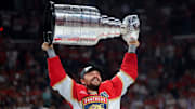 Jun 17, 2025; Sunrise, Florida, USA; Florida Panthers center Sam Reinhart (13) hoists the Stanley Cup after winning game six of the 2025 Stanley Cup Final against the Edmonton Oilers at Amerant Bank Arena. Mandatory Credit: Sam Navarro-Imagn Images
