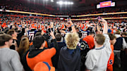 Nov 30, 2024; Syracuse, New York, USA; Syracuse Orange fans celebrate on the field following a game against the Miami Hurricanes at the JMA Wireless Dome. Mandatory Credit: Rich Barnes-Imagn Images