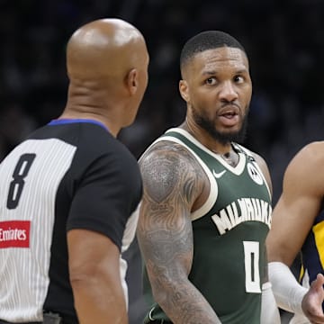 Apr 25, 2025; Milwaukee, Wisconsin, USA; Milwaukee Bucks guard Damian Lillard (0) and Indiana Pacers guard Andrew Nembhard (2) talk with referee Marc Davis during game three of first round for the 2024 NBA Playoffs at Fiserv Forum. Mandatory Credit: Michael McLoone-Imagn Images