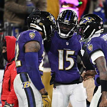 Jan 11, 2025; Baltimore, Maryland, USA; Baltimore Ravens running back Derrick Henry (22) celebrates with wide receiver Nelson Agholor (15) and quarterback Lamar Jackson (8) after scoring a touchdown against the Pittsburgh Steelers in the third quarter in an AFC wild card game at M&T Bank Stadium. Mandatory Credit: Tommy Gilligan-Imagn Images